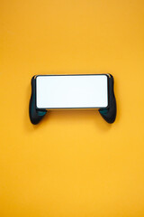 Joystick mobile phone, screen mockup Isolated on yellow background top view