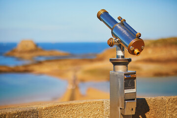 Touristic telescope on the fortress wall surrounding Saint-Malo Intra-Muros in Saint-Malo, France - Powered by Adobe
