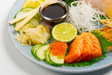 Fototapeta na wymiar sashimi set, Japanese food. sushi restoran menu. Japanese seafood. sashimi set on plate with cucumber and salad. Takea way sashimi set.