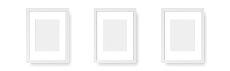 Fototapeta na wymiar White vertical frames. Wall photos on white backdrop. Three empty mockups. Interior design elements. Wooden pictures set with soft shadow. Vector illustration