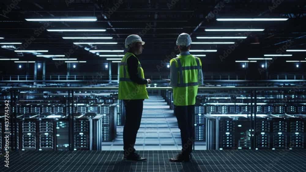 Leinwandbilder data center it specialist and system administrator talk, use tablet computer, wearing safety west. s
