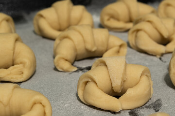 Raw Argentine Croissants (medialunas) pastry cooking with caramel