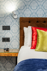 contemporary bedroom upholstered headboard detail with clock resting on the ledge