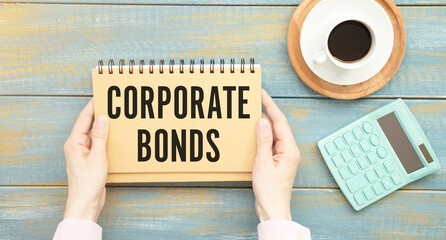 The girl holds a notebook with the text of CORPORATE BONDS in front of her.