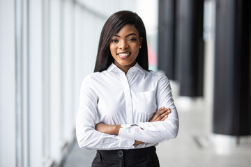 African american young businesswoman standing with arms crossed in office