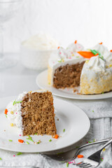Carrot cake with icing and sprinkles at an Easter party
