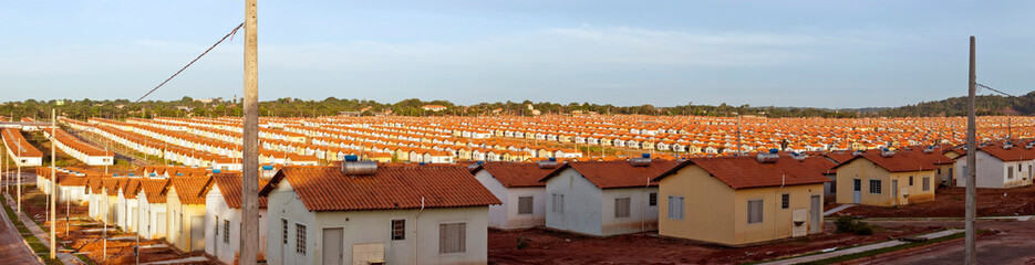Panorama of a neighborhood with many identical popular houses - obrazy, fototapety, plakaty