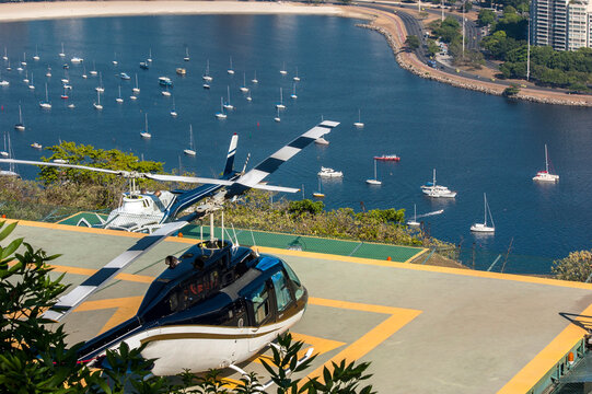 Two Luxury Helicopters On Helipad On Hill