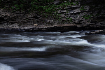 amazing photo of a nordic waterfall during a summer sunrise in Quebec, Canada