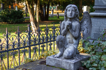 Fototapeta premium A statue of an angel on an ancient tombstone at the Ondrejský cintorín (St. Andrew's Cemetery) in Bratislava. Bratislava, Slovakia. 2020-11-07. 