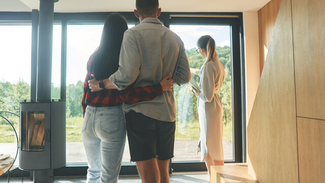 Back view of successful real estate agent woman making presentation of house
