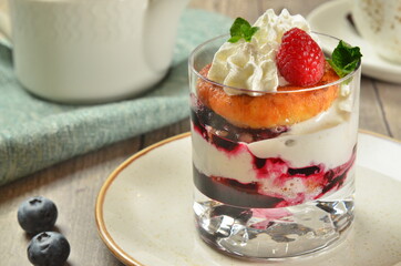 dessert breakfast composition. Sweet delicious dessert with teapot and cup of tea on rustick background