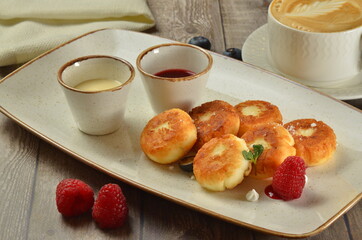 cottage cheese pancakes with sauce and cappuccino coffee breafast composition