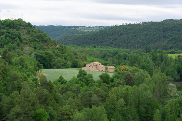 Landscape of a large farmhouse among forests