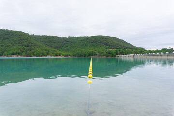 Landscape of a swamp with yellow buoys in line separating a danger zone