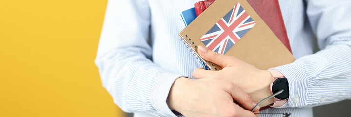 Female silhouette holding diaries with British flag