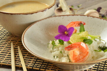 Tom Yam kung Spicy Thai soup with shrimp, seafood, coconut milk and chili pepper in bowl copy space