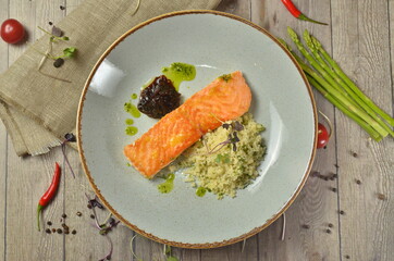 Grilled salmon with garnish on wooden table