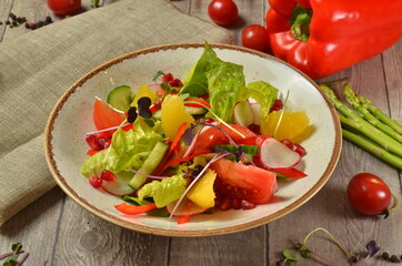 salad with arugula and orange on wooden rustic background