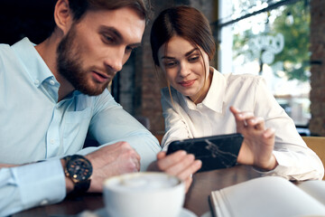 work colleagues sitting at work table communication phone technology emotions
