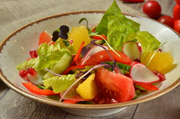 salad with arugula and orange on wooden rustic background