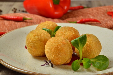 Fried mozzarella cheese stick balls on background with ingredients