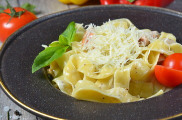pasta with cheese on black plate
