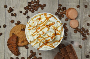 Top view of Latte hot coffee (or cappuccino) roasted coffee beans and ingredients on wooden table