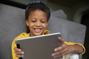 Girl playing games online on a tablet