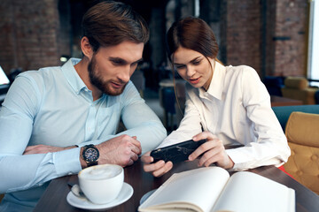 man and woman sitting in cafe breakfast business colleagues