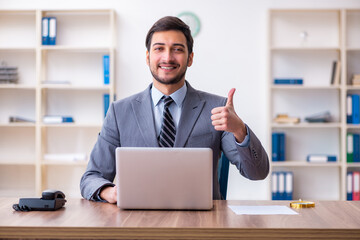 Young handsome businessman employee working in the office