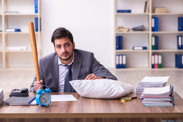 Young male employee in oversleeping concept