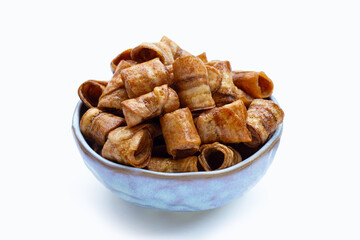 Dried banana rolled chips in bpwl on white background.
