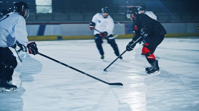 Ice Hockey Rink Arena: Professional Forward Player Breaks Defense, Hitting Puck with Stick Scores Goal, Goalie Missed it. Team Celebrates Winning. Cinematic Slow Motion Tracking Full