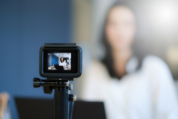 Business woman or blogger recording vlog on digital camera and live stream.
