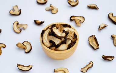 Dried shiitake mushrooms on white background.