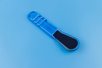 Blue pedicure grater on blue background