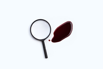 Magnifying glass with blood on white background.