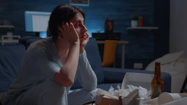 Unhappy, depressed, frustrated, psychotic alone woman sitting on couch feeling disappointed and vulnerable, suffering from insomnia, stress anxiety, mental problems, suicidal thoughts, chronic disease