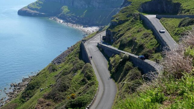 High angle view of cars driving up and down steep sharply winding road in Great Orme, famous tourist resort town Llandudno in Wales.