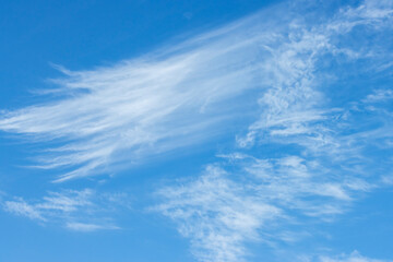 Naklejka na ściany i meble Clouds against the blue sky, natural landscape.