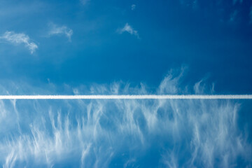 Sky and airplane trail, beautiful landscape of cloudy sky.