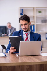 Two male employees working in the office