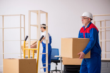 Two male professional movers doing home relocation