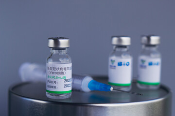 Syringe and glass vials with coronavirus vaccine. Global worldwide vaccination and health care. 