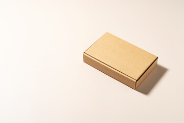 Cardboard boxes placed on a beige background.