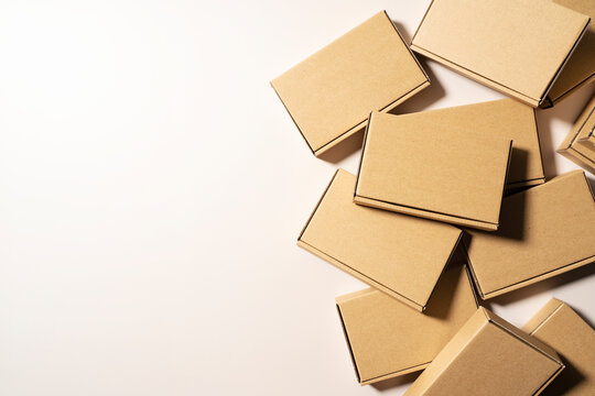 Cardboard boxes placed on a beige background.