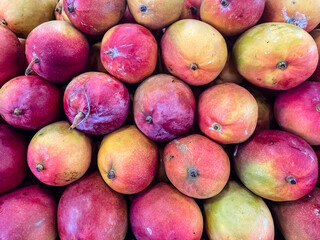 Various fresh mangoes for sale in the market.
