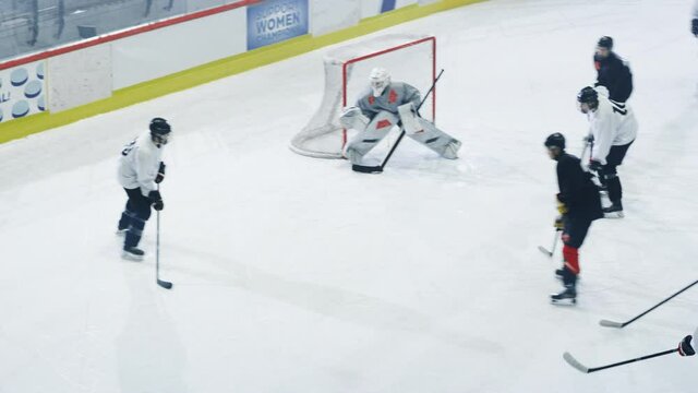 Ice Hockey Rink Arena: Great Team Attacks, Plays Pass Using Tactics and Creative Strategy. Player Masterful Dribbles. Beautiful Energetic Game from Team. Aerial Drone High Angle Tracking Shot