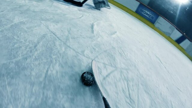 POV: Ice Hockey Professional Forward Player Dribbles, Hitting Puck with Stick Scores Perfect Goal when Goalie Misses. Cinematic Documentary Style Camera Fixed on Hockey Stick. Point of View Shot